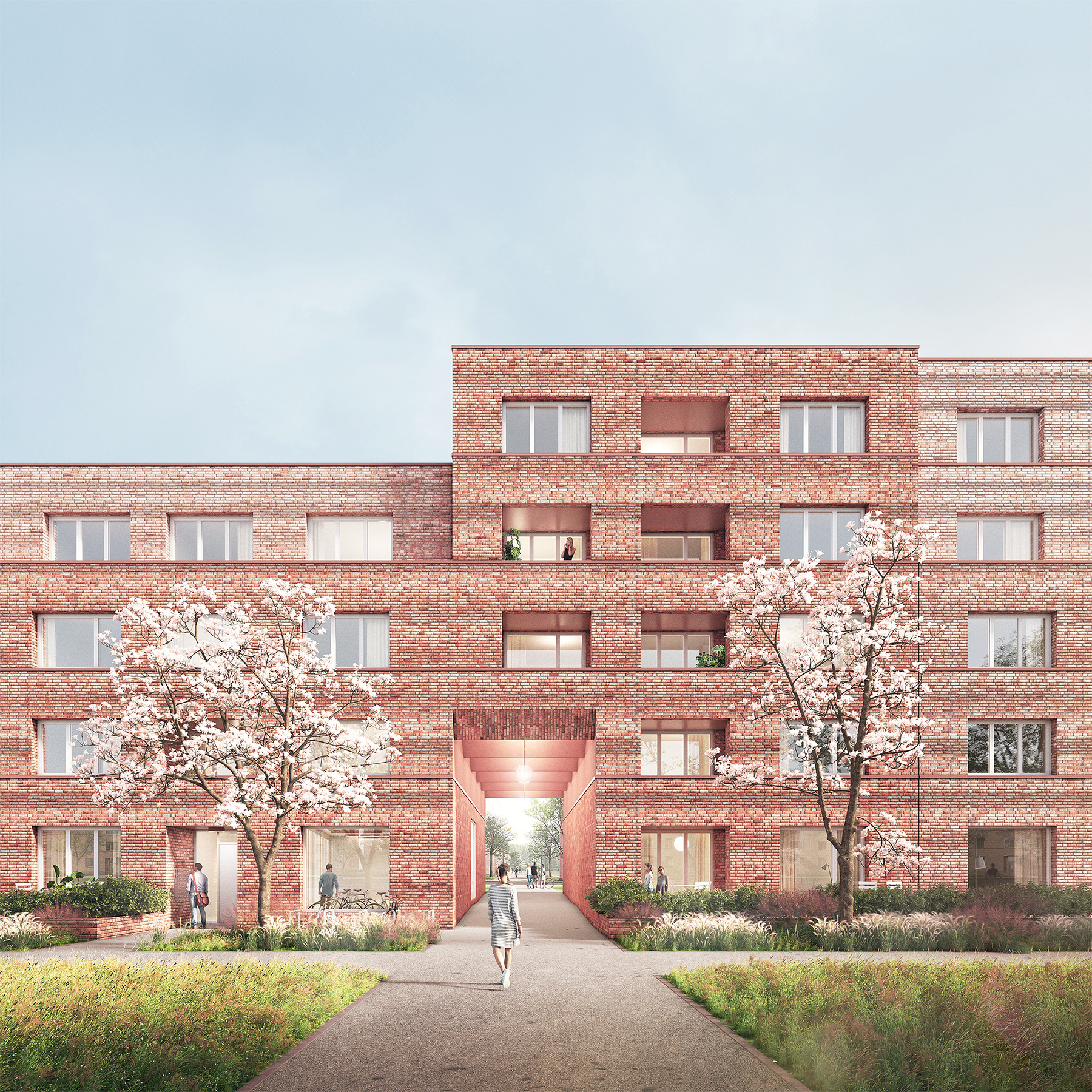 Eingang der Klinker-Mehrfamilienhäuser im Scharnhorst-Quartier mit zwei blühenden Bäumen davor